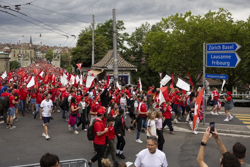 Swiss fans walk from old town in Bern over the Nydegg bridge towards the stadium during a fanwalk prior to the UEFA Women&#039;s EURO 2025 Group A soccer match between Switzerland and Iceland at the W ...
