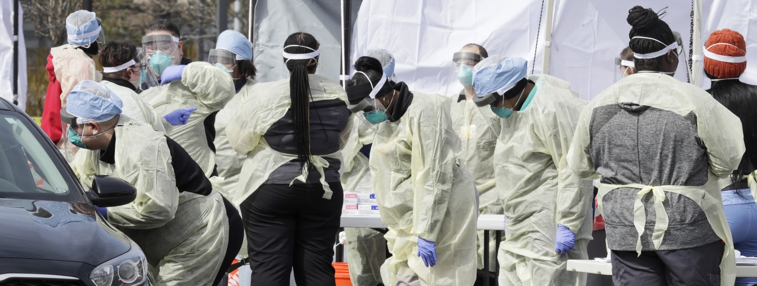 A caregiver tests a patient for coronavirus at University Hospitals, Monday, March 16, 2020, in Mayfield Heights, Ohio. At this site, there is a capability to test 300 people today. Cleveland Clinic a ...