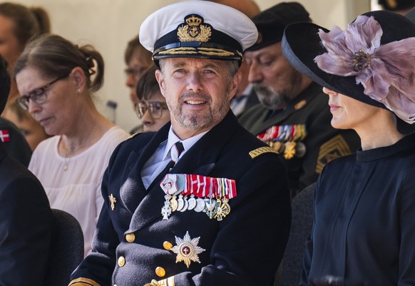 Denmarks Crown Prince Frederik, second right, and Crown Princess Mary, right, attend a wreath-laying ceremony during the annual Flag Day at Kastellet in Copenhagen, Denmark, Tuesday Sept. 5, 2023, to  ...