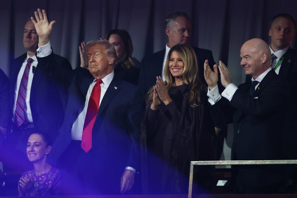President Donald Trump and First Lady Melania Trump and FIFA President Gianni Infantino gesture at the end of the draw for the 2026 soccer World Cup at the Kennedy Center in Washington, Friday, Dec. 5 ...
