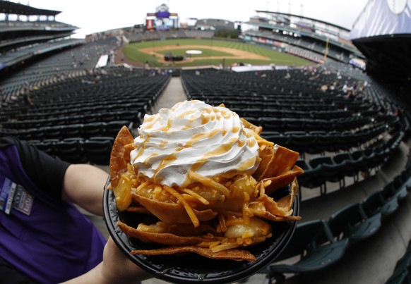 A bowl of apple pie nachos is shown at Coors Field in Denver, Saturday, May 6, 2017. The $6 bowl consists of cinnamon-covered nacho chips, apple pie filling and cheddar cheese, topped with whipped cre ...