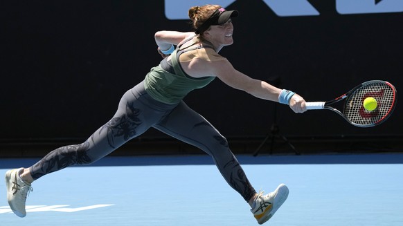 Madison Brengle of the U.S. plays a backhand return to Dayana Yastremska of Ukraine during their first round match at the Australian Open tennis championships in Melbourne, Australia, Monday, Jan. 17, ...