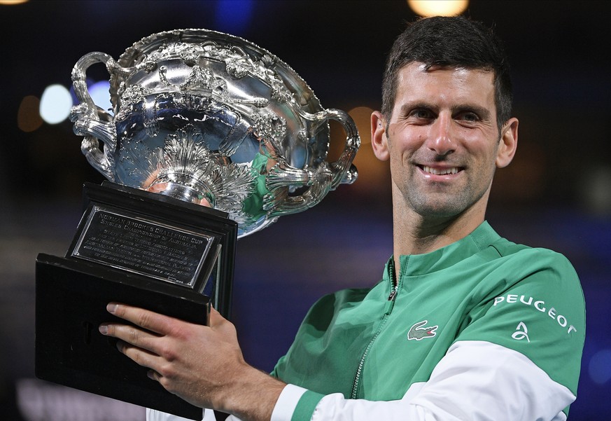 FILE - Serbia&#039;s Novak Djokovic holds the Norman Brookes Challenge Cup after defeating Russia&#039;s Daniil Medvedev in the men&#039;s singles final at the Australian Open tennis championship in M ...