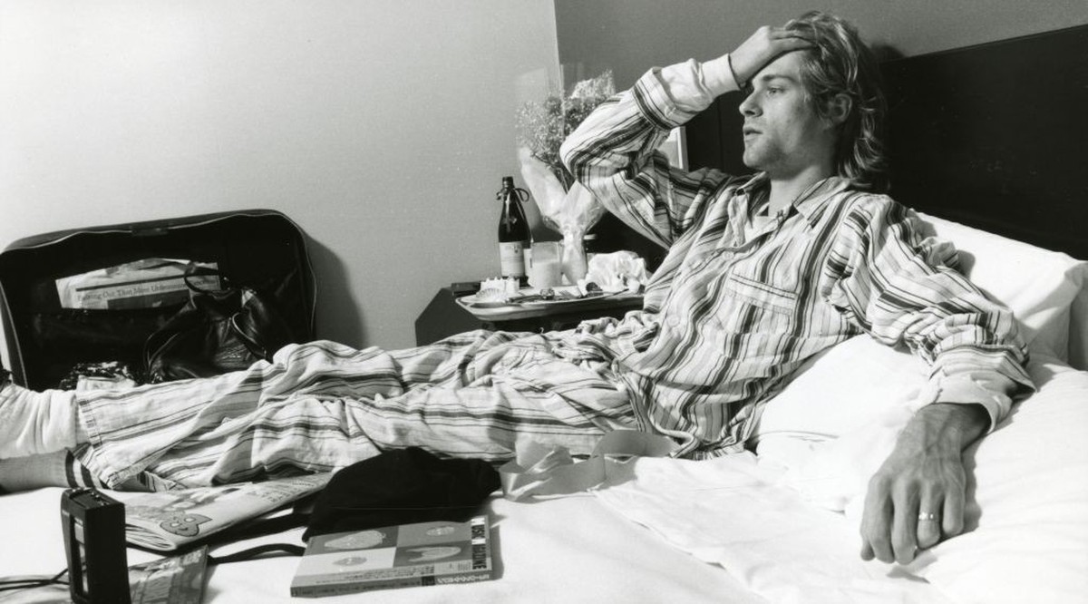 (MANDATORY CREDIT Gutchie Kojima/Shinko Music/Getty Images) Kurt Cobain of Nirvana, lying in bed wearing pyjamas in Roppongi Prince Hotel in Tokyo, Japan, during an interview, 19th December 1992. (Pho ...