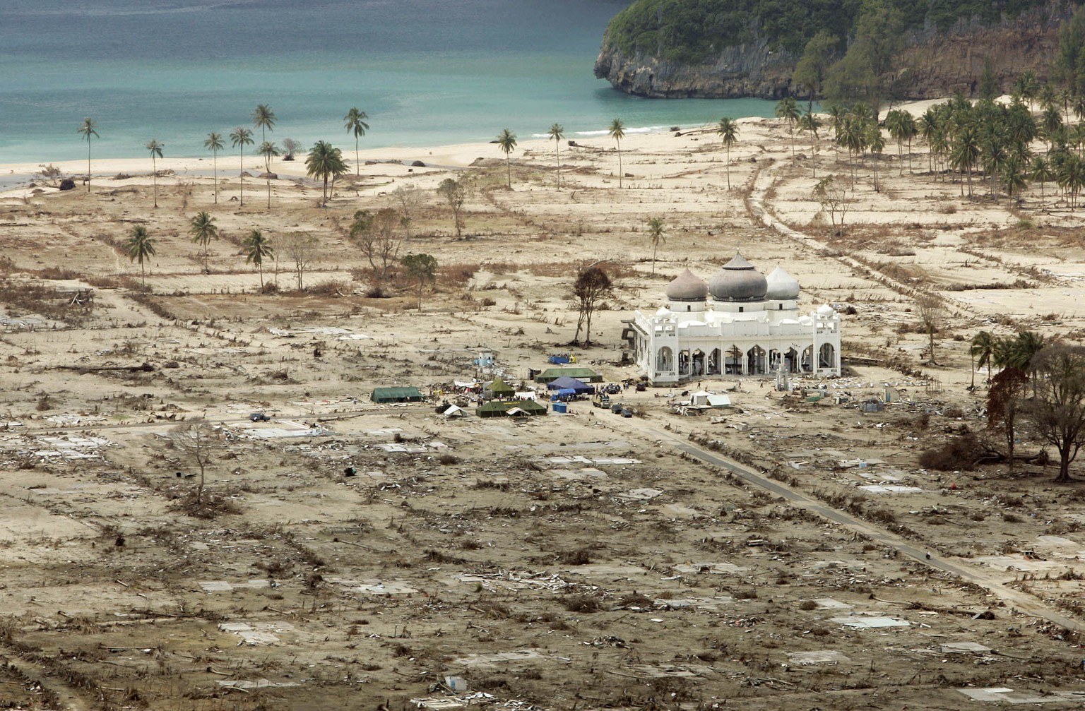 FILE - In this Jan. 30, 2005 file photo, the Rahmatullah Lampuuk Mosque stands intact after the 2004 tsunami hit the area in Lhoknga, near Banda Aceh, Indonesia. When the powerful tsunami smashed into ...