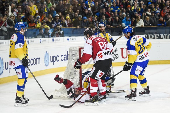 Team Canada&#039;s Chris Didomenico, down, and James Sheppard, celebrate after Didomenico scored 2-0 against Davos&#039; goalkeeper Leonardo Genoni, during the game between Team Canada and Switzerland ...