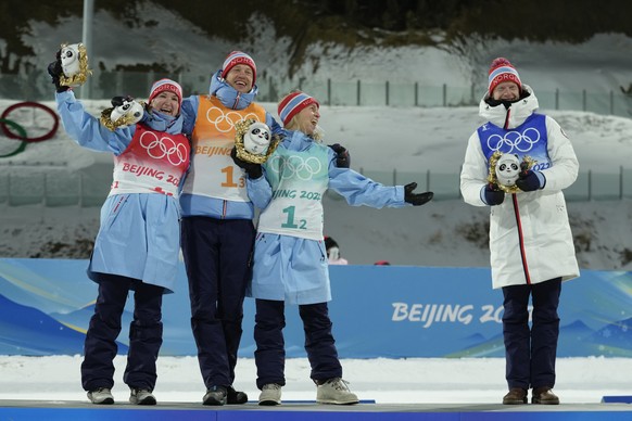 From left, Marte Olsbu Roeiseland of Norway, Tarjei Boe, Tiril Eckhoff and Johannes Thingnes Boe pose during the flower ceremony after their first place showing in the biathlon 4x6-kilometer mixed rel ...