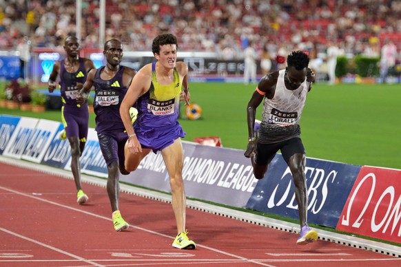 KEYPIX - Dominic Lokinyomo Lobalu, of Switzerland, right, crosses the finish line ahead of Graham Blanks, of the United States, to win the men's 5000 meters during the Herculis Diamond League ath ...