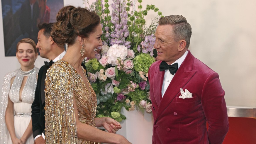 Britain's Kate, Duchess of Cambridge, left, speaks with British actor Daniel Craig as he arrives for the world premiere of the new film from the James Bond franchise 'No Time To Die', ...