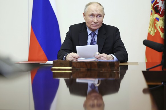 Russian President Vladimir Putin chairs the Security Council meeting via videoconference at the Novo-Ogaryovo State residence outside Moscow, Russia, Tuesday, Feb. 13, 2024. (Alexander Kazakov, Sputni ...