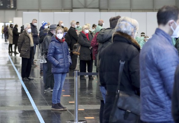 People are waiting for a mass Covid-19 testing from soldiers of the Austrian army in Vienna, Austria, Friday, Dec 4, 2020. Written on the poster &quot; corona test street&quot;. Austria conducts a mas ...