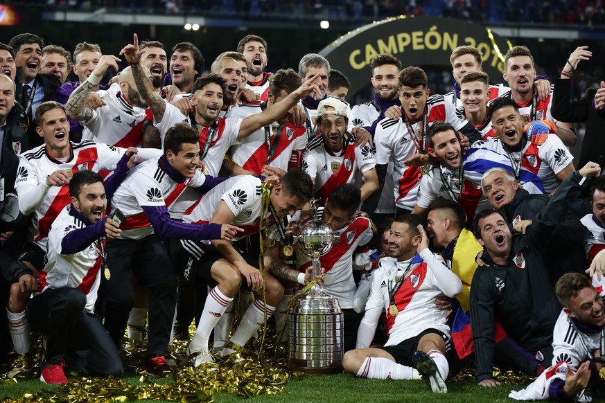Players of Argentina&#039;s River Plate celebrate with the trophy after beating Argentina&#039;s Boca Juniors in the Copa Libertadores final soccer match at the Santiago Bernabeu stadium in Madrid, Sp ...