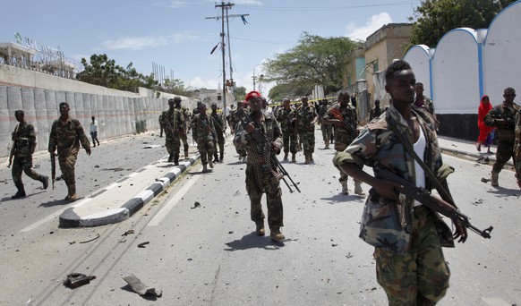 FILE - In this Tuesday, Aug. 30, 2016 file photo, Somali government soldiers patrol following a blast near the presidential palace in the capital Mogadishu, Somalia. The Somalia-based Islamic extremis ...