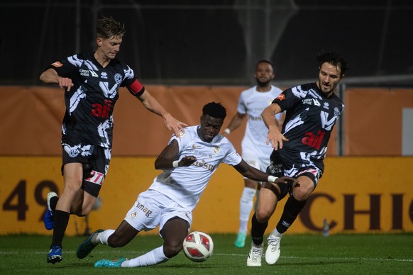 From left: Lugano&#039;s player Roman Macek, Young Boys&#039; player Ebrima Colley and Lugano&#039;s player Anto Grgic, during the Super League soccer match FC Lugano - BSC Young Boys, at the Cornared ...