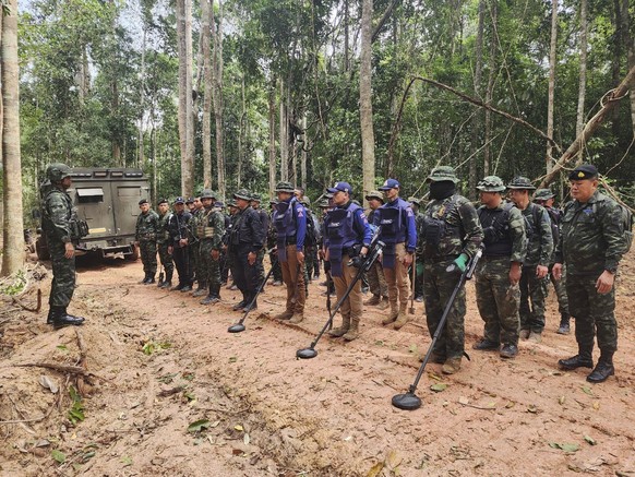 In this Sunday, July, 2025, photo released by the Royal Thai Army, Thai soldiers inspect a border area in Ubon Ratchathani