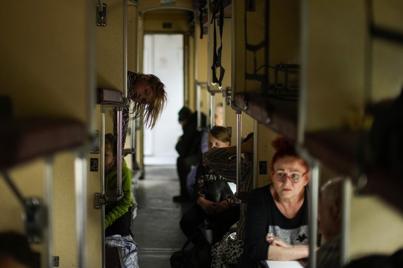 People fleeing from Lysychansk and other areas sit in an evacuation train at the train station in Pokrovsk, eastern Ukraine, eastern Ukraine, Saturday, May 28, 2022. Fighting has raged around Lysychan ...