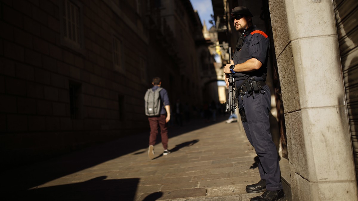 A member of Catalan police stands guard next to the Palau Generalitat in Barcelona, Spain, Monday Oct. 30, 2017. Catalonia's civil servants face their first full work week since Spain's cent ...