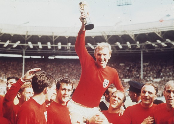 The July 30, 1966 photo shows England&#039;s soccer captain Bobby Moore, carried shoulder high by his team mates, holding aloft the World Cup trophy. England defeated Germany 4-2 in the final, played  ...