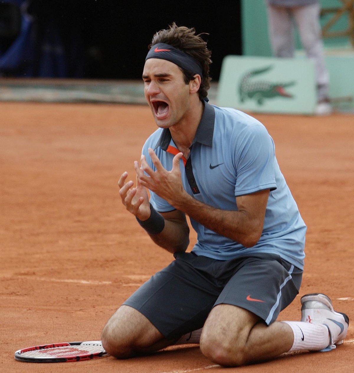 Switzerland's Roger Federer jubilates after defeating Sweden's Robin Soderling during their men's singles final match of the French Open tennis tournament at the Roland Garros stadium i ...