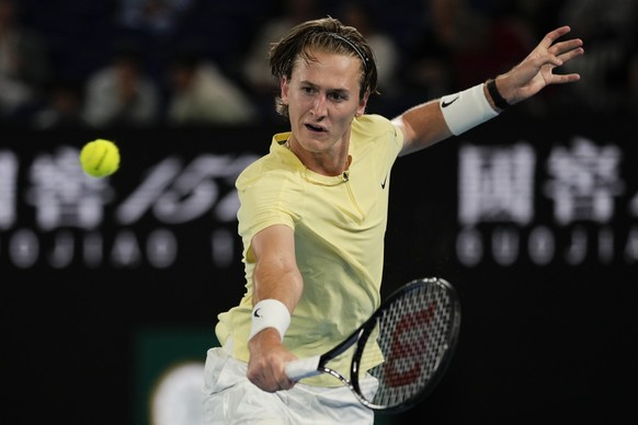 Sebastian Korda of the U.S. plays a backhand return to Daniil Medvedev of Russia during their third round match at the Australian Open tennis championship in Melbourne, Australia, Friday, Jan. 20, 202 ...