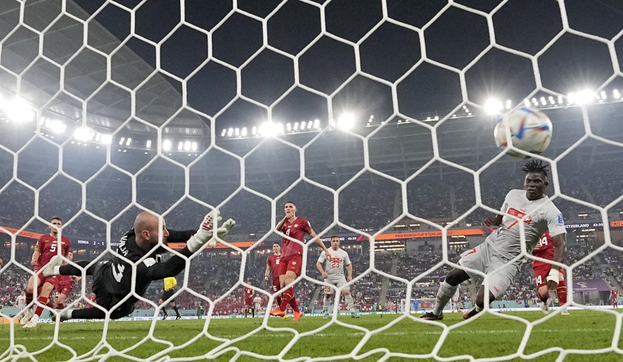 Switzerland's Breel Embolo scores his side's second goal against Serbia's goalkeeper Vanja Milinkovic-Savic during the World Cup group G soccer match between Serbia and Switzerland, at the Stadium 974 ...