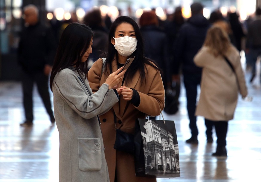 epa08256436 People wearing protective face masks in Milan, Italy, 28 February 2020. The number of people infected with the novel coronavirus (Covid-19) disease who have died in Italy has risen to 17.  ...