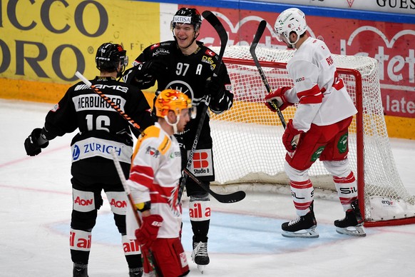 Lugano&#039;s player Calvin Thuerkauf, center, celebrates the 3-1 goal with Lugano&#039;s player Raphael Herburger, left, during the preliminary round game of National League Swiss Championship 2022/2 ...