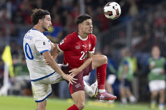 Switzerland's Fabian Rieder, right, against Kosovo's Leon Avdullahu, during the FIFA 2026 World Cup Group B qualifying soccer match between Switzerland and Kosovo at the St. Jakob-Park stadi ...