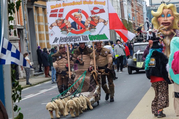 epa12743629 Carnival goers featuring a satirical take on US President Donald Trump and Greenland take part in the parade on the first day of the Carnival of Aalst, in Aalst, Belgium, 15 February 2026. ...