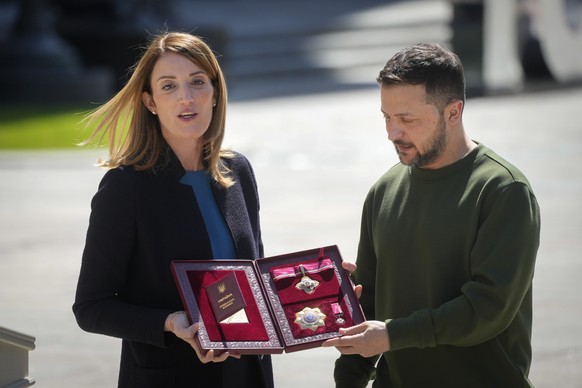 Ukrainian President Volodymyr Zelenskyy, right, hands the Ukrainian state award to European Parliament President Roberta Metsola before their press conference in Kyiv Ukraine, Thursday, May 9, 2024. ( ...