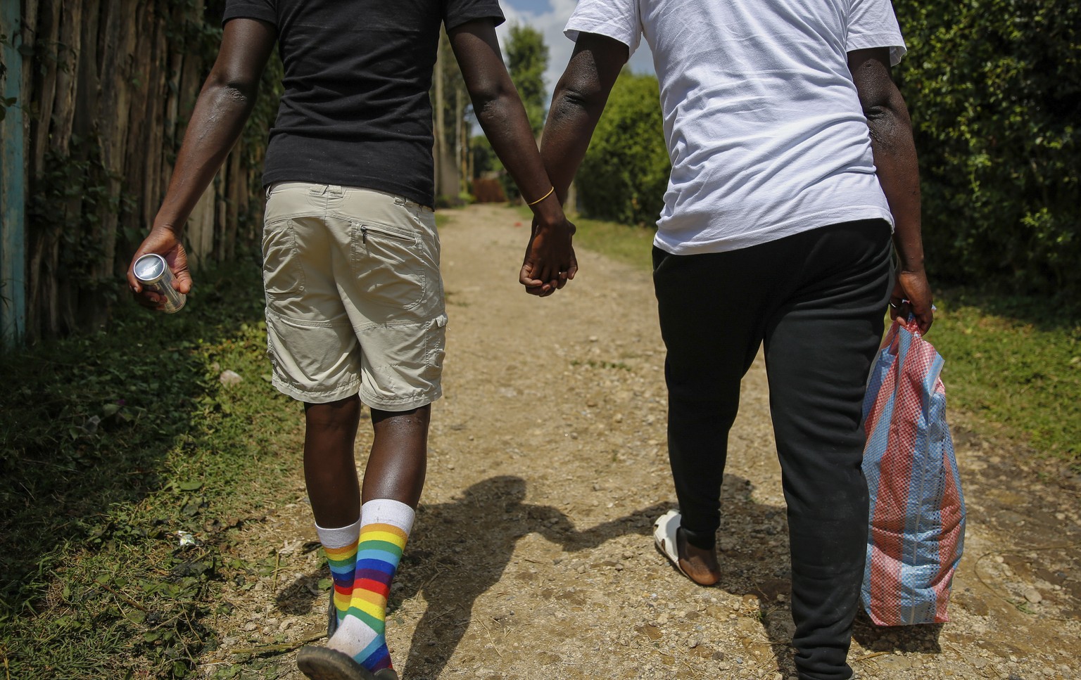 FILE - Gay Ugandan refugees who fled from their country to neighbouring Kenya, return after shopping for food in Nairobi, Kenya on June 11, 2020. Ugandan lawmakers passed a bill Tuesday, March 21, 202 ...