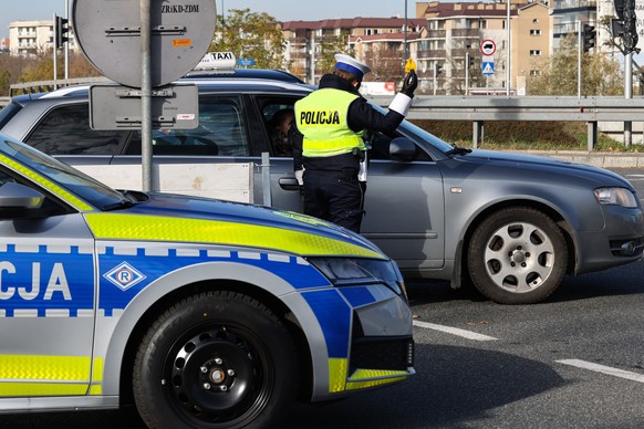 epa12497060 Police officers maintain order and security in front of the Old Powazki Cemetery in Warsaw, Poland, 01 November 2025. In the Catholic Church, November 1 is All Saints&#039; Day. The Church ...