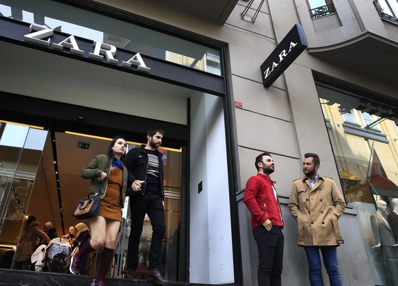 FILE - In this Friday, Nov. 3, 2017 file photo, people exit and a branch of fashion retailer Zara in an upscale Istanbul neighbourhood. Zara said Monday, Nov. 6, 2017, it is working on establishing a ...