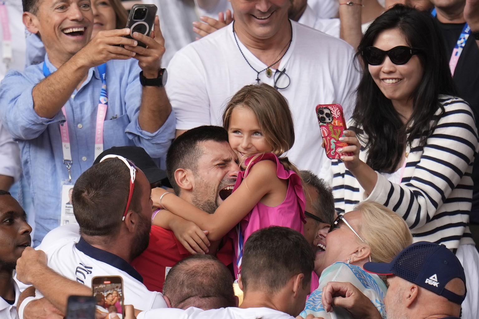 Serbia&#039;s Novak Djokovic embraces his daughter Tara after defeating Spain&#039;s Carlos Alcaraz in the men&#039;s singles tennis final at the Roland Garros stadium during the 2024 Summer Olympics, ...