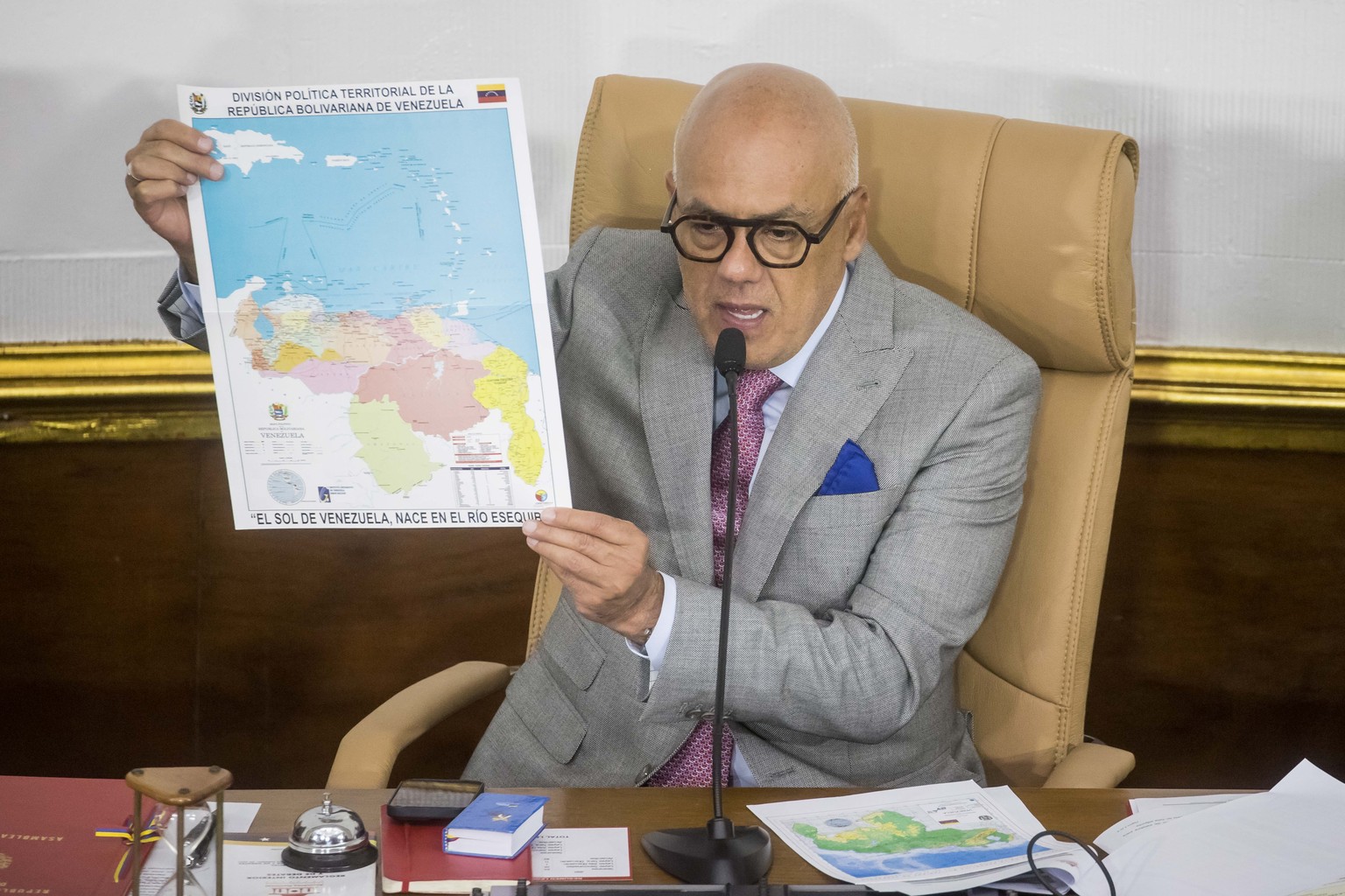 epa11014919 President of the National Assembly, Jorge Rodriguez, shows a map of Venezuela with the accession of Essequibo during a body session in Caracas, Venezuela, 06 December 2023. The National As ...