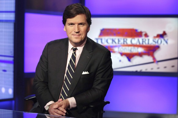 FILE - Tucker Carlson, host of &quot;Tucker Carlson Tonight,&quot; poses for photos in a Fox News Channel studio on March 2, 2017, in New York. The Delaware judge overseeing Dominion Voting Systems&#0 ...