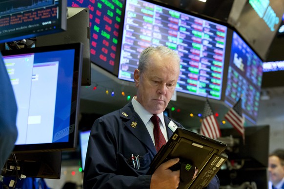 Trader James Riley works on the floor of the New York Stock Exchange, Wednesday, Dec. 6, 2017. U.S. stocks held steady in Wednesday morning trading, following sharp drops for markets around the world. ...