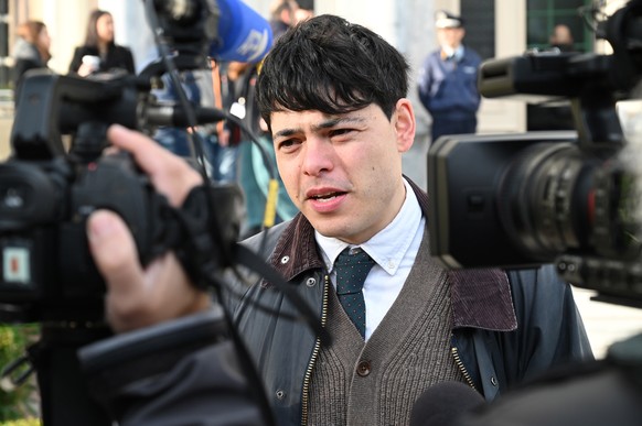 epa10397918 Rescuer Sean Binder, one of the 24 defendants facing trial over refugee rescues, makes a statement to the press outside a courthouse in Mytilini, Lesvos Island, Greece, 10 January 2023. Tw ...