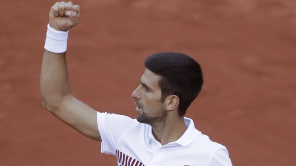 Serbia&#039;s Novak Djokovic clenches his fist after scoring a point against Spain&#039;s Albert Ramos-Vinolas during their fourth round match of the French Open tennis tournament at the Roland Garros ...