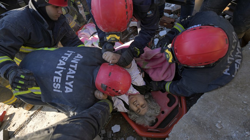 Rescue teams evacuate a survivor from the rubble of a destroyed building in Kahramanmaras, southern Turkey, Tuesday, Feb. 7, 2023. A powerful earthquake hit southeast Turkey and Syria early Monday, to ...