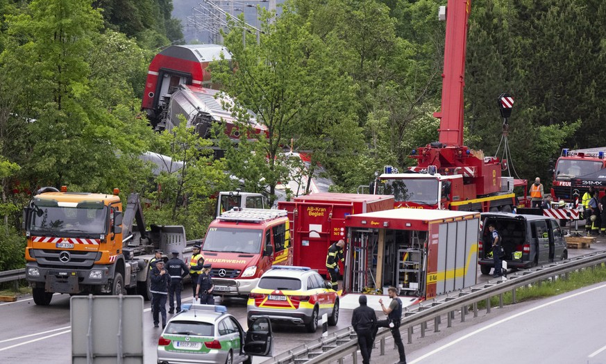 Emergency and rescue forces work on the site of a train crash in Burgrain, Germany, Friday, June 3, 2022. Authorities say a train accident in the Alps in southern Germany on Friday left at least four  ...