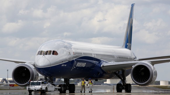 FILE - Boeing employees walk the new Boeing 787-10 Dreamliner down towards the delivery ramp area at the company&#039;s facility after conducting its first test flight at Charleston International Airp ...