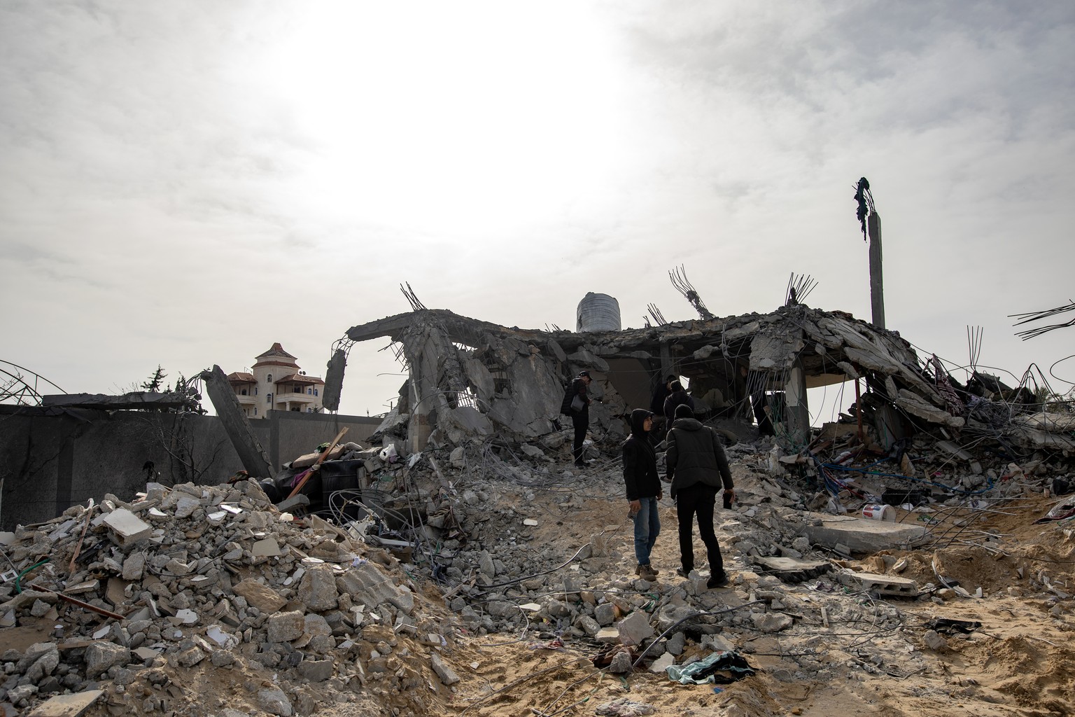 epa11244065 Northern Gaza displaced Palestinians from the Abu Nuqira family inspect their home after an Israeli air strike, in the Rafah refugee camp, southern Gaza Strip, 26 March 2024. More than 32, ...