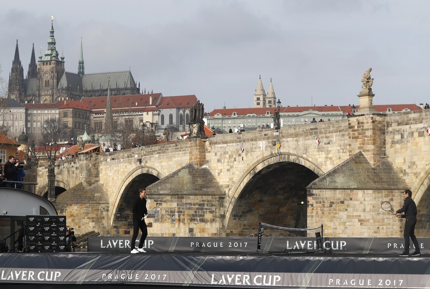 Switzerland&#039;s tennis player Roger Federer, right, returns a ball to Czech Republic&#039;s Tomas Berdych, left, during an exhibition match on Vltava river in Prague, Czech Republic, Monday, Feb. 2 ...