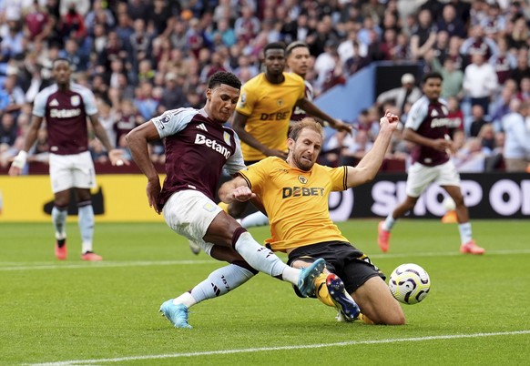 Aston Villa&#039;s Ollie Watkins, left, scores past Wolverhampton Wanderers&#039; Craig Dawson during the English Premier League soccer match between Aston Villa and Wolverhampton Wanderers at Villa P ...