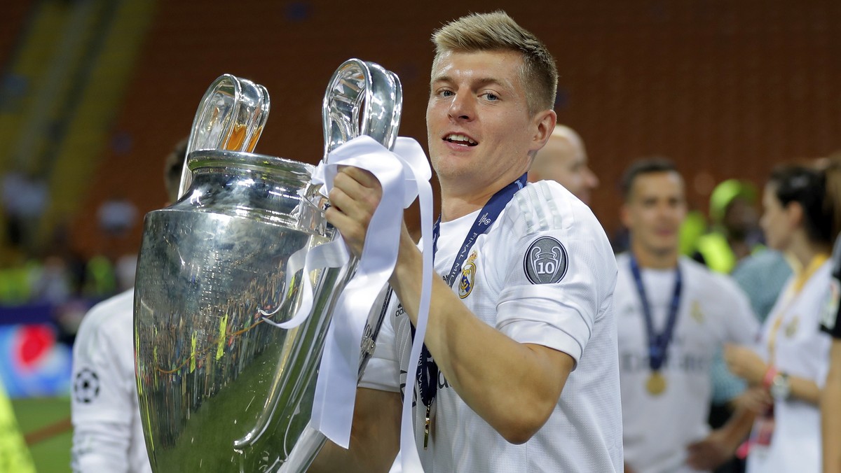 FILE - In this May 28, 2016 file photo, Real Madrid's Toni Kroos celebrates with the trophy after the Champions League final soccer match between Real Madrid and Atletico Madrid at the San Siro s ...