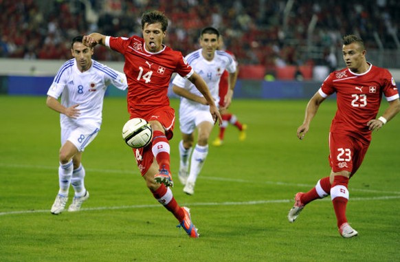 Switzerland`s Valentin Stocker, left and Xherdan Shaqiri fighting for the ball during the 2014 World Cup Brazil group E qualification soccer match between Switzerland and Albania at the Swisspor Arena ...