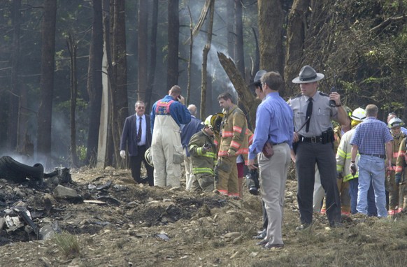 Firefighters and emergency personnel investigate the scene of a fatal crash involving a United Airlines Boeing 757 with at least 45 passengers Tuesday morning, September 11, 2001 near Shanksville, Pa. ...