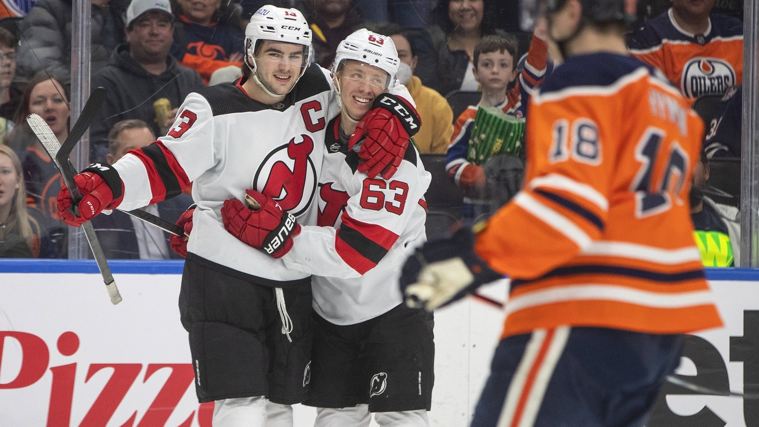 March 19, 2022, EDMONTON, AB, CANADA: New Jersey Devils Nico Hischier 13 and Jesper Bratt 63 celebrate a goal against the Edmonton Oilers during third period NHL, Eishockey Herren, USA action in Edmon ...