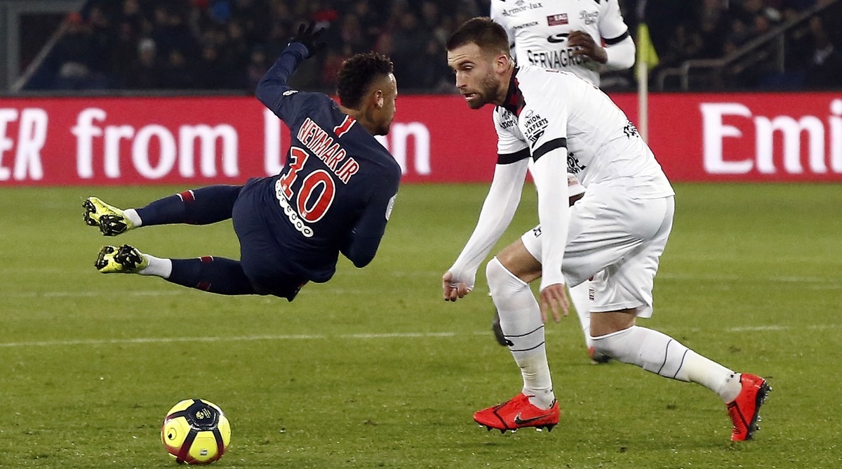 PSG's Neymar, left, is fouled by Guingamp's Lucas Deaux during the League One soccer match between Paris Saint Germain and Guingamp at the Parc des Princes stadium in Paris, Saturday, Jan. 1 ...